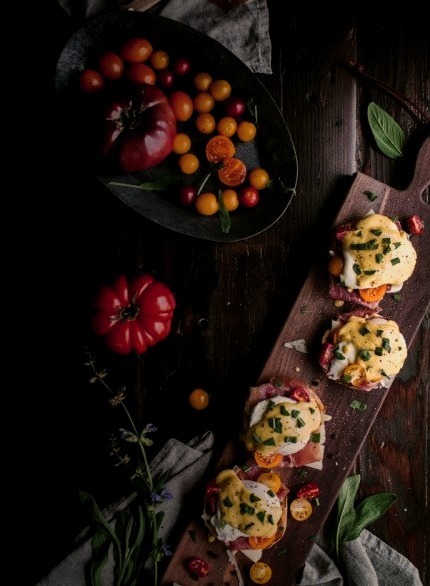 Eggs Benedict With Manchego, Tomatoes, Prosciutto & A Sage Hollandaise SauceSource
